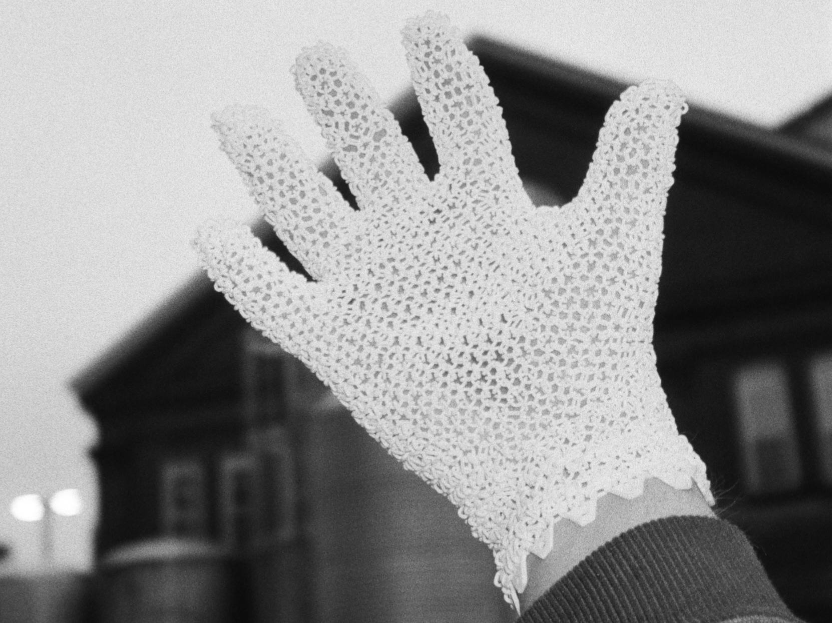 A printed Starsuit glove held up against the sky